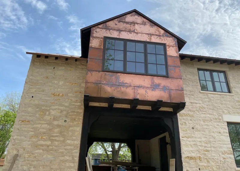 Copper metal panel facade on a stone building for Skylight Installation in Tanaina