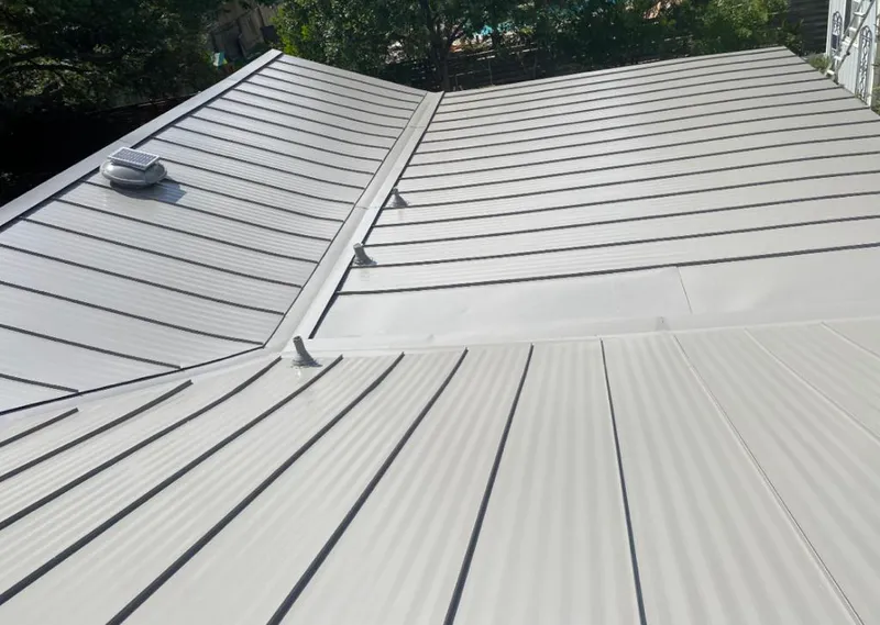 Solar attic fan installed on a metal roof for Roof Ventilation in Tanaina